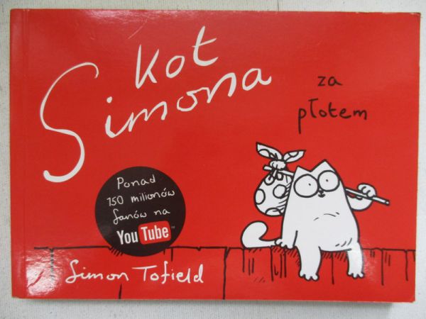 Kot a za płotem