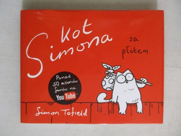 Kot a za płotem
